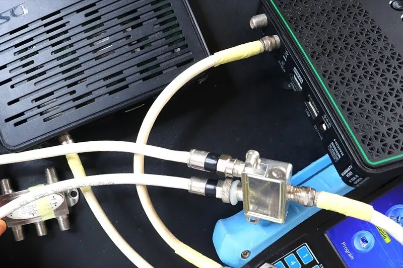 Coaxial cables and a splitter connected at the back of a decoder