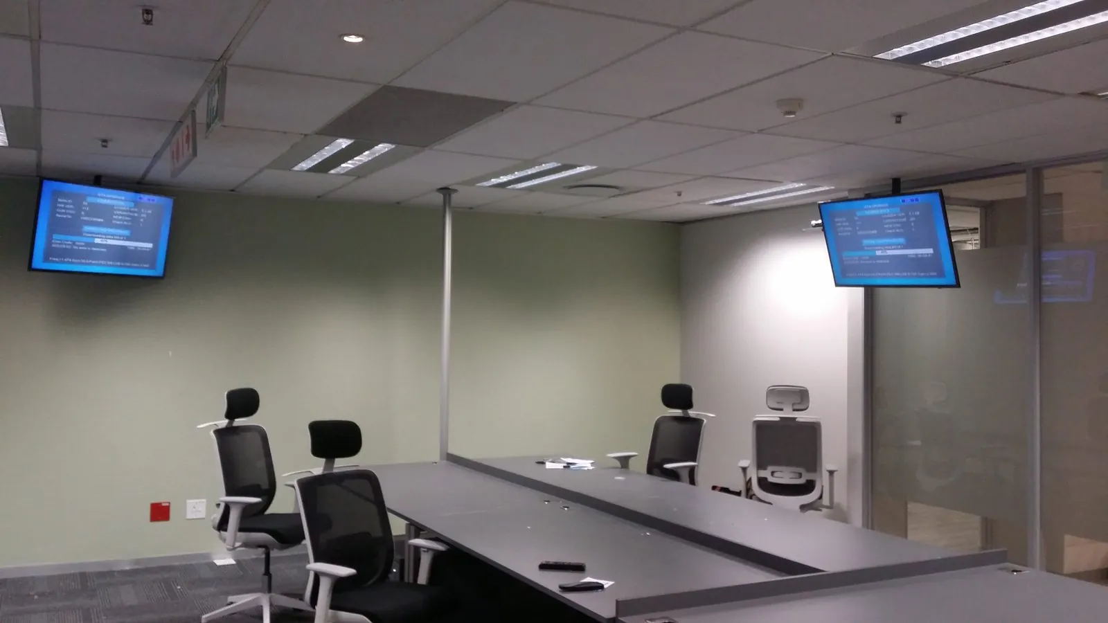 Modern boardroom with wall-mounted TV screens